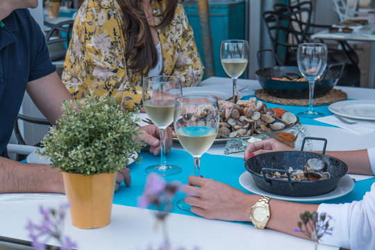 Friends Eating Seafood In A Restaurant