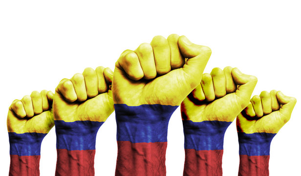 A raised fist of a protesters painted with the Colombia flag