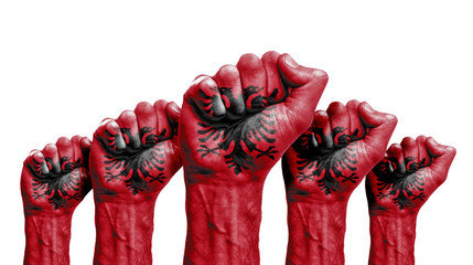 A raised fist of a protesters painted with the albania flag