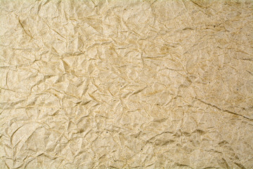 Background from crumpled paper of brown color.