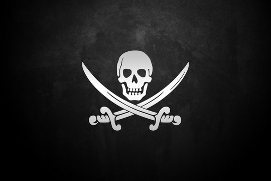 Ripped tear grunge old fabric texture of the pirate skull flag waving in wind, calico jack pirate symbol at cloudy sky with sun rays light, dark mystery style, hacker and robber 
