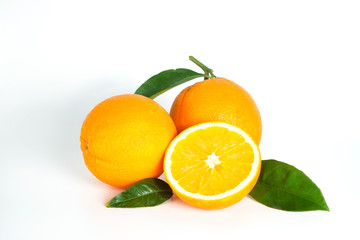 Close up image of juicy organic whole and halved oranges with green leaves & visible core texture, isolated white background, copy space. Macro shot of bright citrus fruit slices. Top view, flat lay.