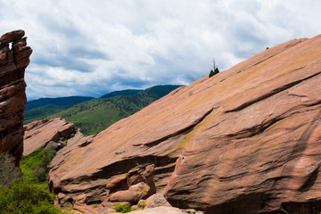 Rock formation in front of grassy hills