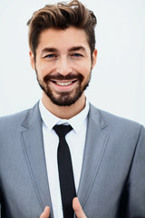 handsome young man in suit on grey background