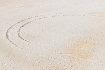 Fototapeta na wymiar Tire track on the sandy beach, footprints and traces