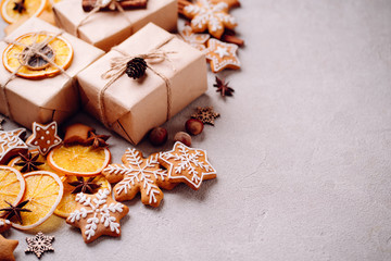 Christmas scene. Holiday greeting card design. Traditional festive gingerbread cookies, handmade gift boxes and natural decorations, template with copyspace