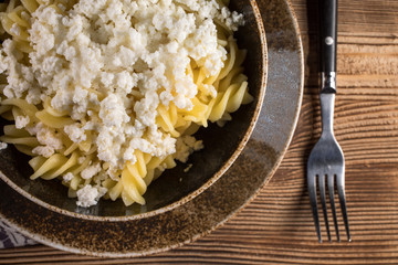 Fusilli pasta with cottage cheese, sugar and cinnamon.