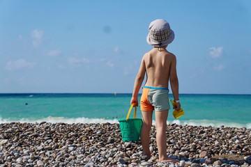 toddler child playing on sand beach on summer holidays, turkey beach, summer holidays at sea © zagoryanskiyv