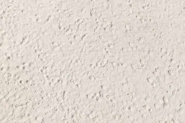 Footprints at white sandy beach, top view