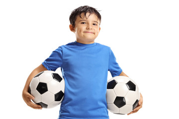 Boy holding two soccer balls