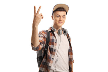 Male student with headphones gesturing a peace sign
