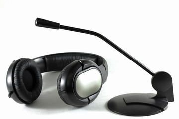 Black microphone and headphones for communication and recording.