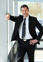 portrait of confident businessman on blurred background