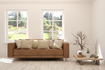 Fototapeta premium Stylish room in white color with sofa and summer landscape in window. Scandinavian interior design. 3D illustration