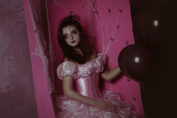 scary girl, dead girl, like a zombie, doll, near the coffin with spiders, in a pink dress, on Halloween holiday