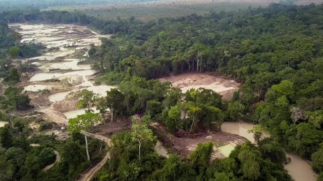 Aerial view of deforested area of the Amazon rainforest caused by illegal gold mining activities. Concept of deforestation, environmental damage, climate change and global warming. Para state, Brazil.
