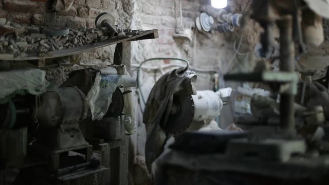 Lapidary workshop. Spare rocks, Cutting mashine, polishing discs for working semiprecious stones. La Toma, San Luis, Argentina