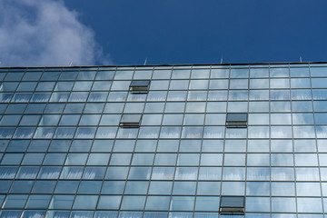 Obraz premium underside panoramic and perspective view to steel blue glass high rise building skyscrapers, business concept of successful industrial architecture