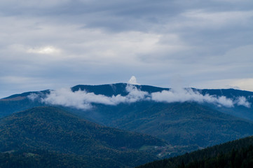 Mountain landscape with smoke fog and clouds over the rocks.