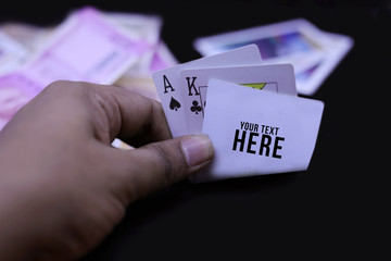 Hand holds a combination in poker - three of a kind on a black background. Close up.