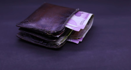 men's purse with Indian currency note inside on the black background