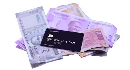 Indian currency note with credit and debit cards on the white background