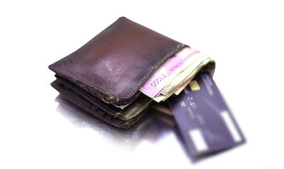 men's purse with money, credit and debit cards on the white table