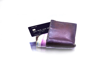 men's purse with money, credit and debit cards on the white table