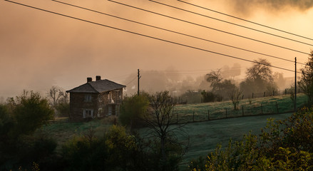 Brick house surrounded by morning mist