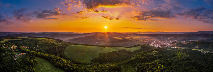 Aerial view of green valley during colorful sunset