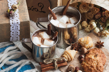 Metal mugs with cacao and marshmallows