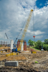 Fototapeta na wymiar Crane on the construction of a bridge.