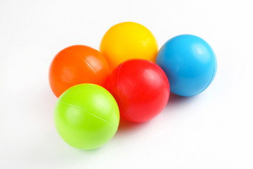 Colored plastic balls on white background