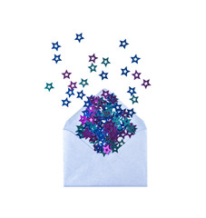 Top view of colorful confetti stars in silver festive envelope. Christmas holidays concept.