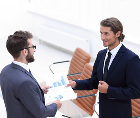 two businessmen talking in the office.