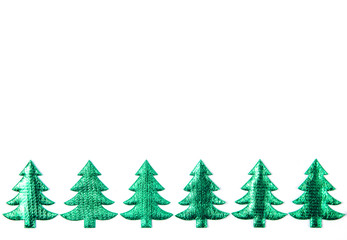 Green decorative Christmas trees in a row. Copy space. Christmas holiday decorations. Seamless pattern.