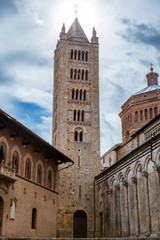 Fototapeta na wymiar View of the bell tower of Massa Marittima in Tuscany with the sun in the background