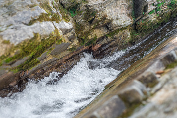 The flow of water between stones in a mountain river