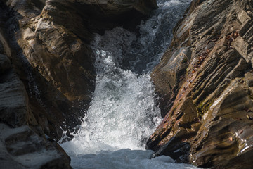 The flow of water between stones in a mountain river