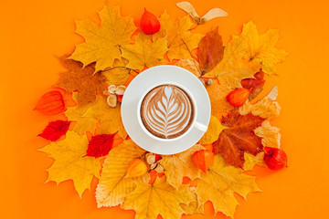 Coffee latte cup in dry autumn leaves wreath frame