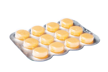 Orange Blisters with color cough drops isolated on a white background.
