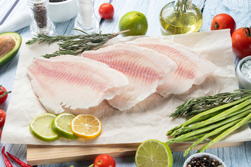 photo seafood and fish on parchment with vegetables on the Board
