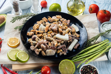 photo seafood and fish on parchment with vegetables on the Board