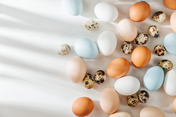 Natural Colored brown, quail and white Eggs with sunlights. Compositions in pastel colors. Easter consept.  Flat lay, top view .