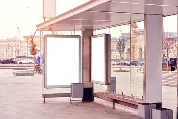 Billboard, advertising city format in Moscow on public bus stop, mockup of a two blank white poster. Traffic in town.