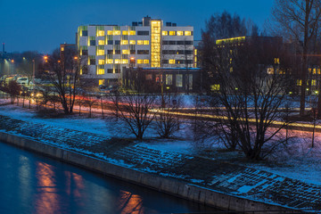 Modern design of the building. Modern architecture. Snow on the ground.