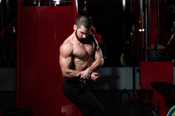 Fototapeta na wymiar Bodybuilder Flexing Muscles