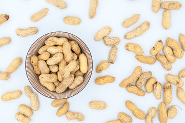 peanuts in shells in a bowl isolated on white background