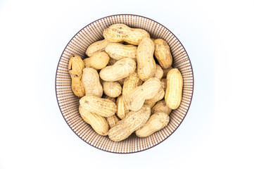peanuts in shells in a bowl isolated on white background