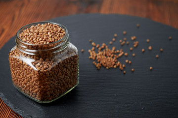 buckwheat in a jar close-up on a dark background